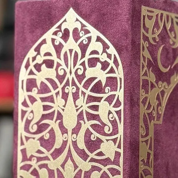 A gold arch cut by hand on burgundy cloth